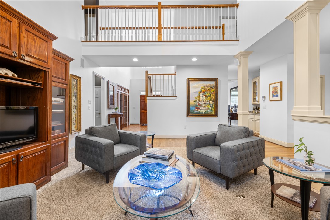 106 Red Maple Way Clemson, SC 29631 - Photo 5 of 49 An open living space features soaring ceilings, structured columns, and a overlooking upper hallway balcony.