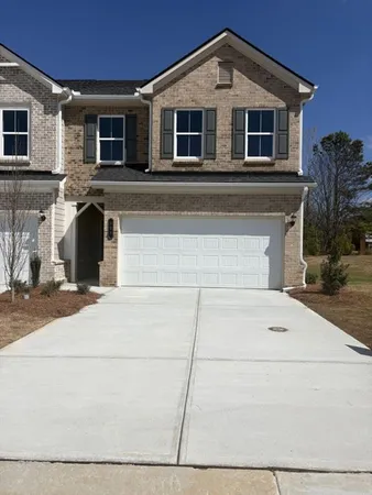 a front view of a house with garage