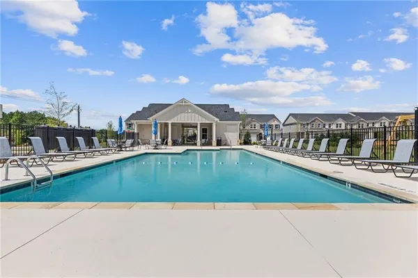 a view of swimming pool with outdoor seating