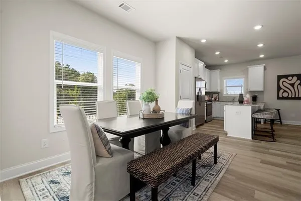 a view of a dining room with furniture window and wooden floor