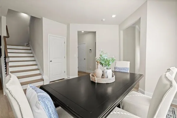 a view of a dining room with furniture and wooden floor
