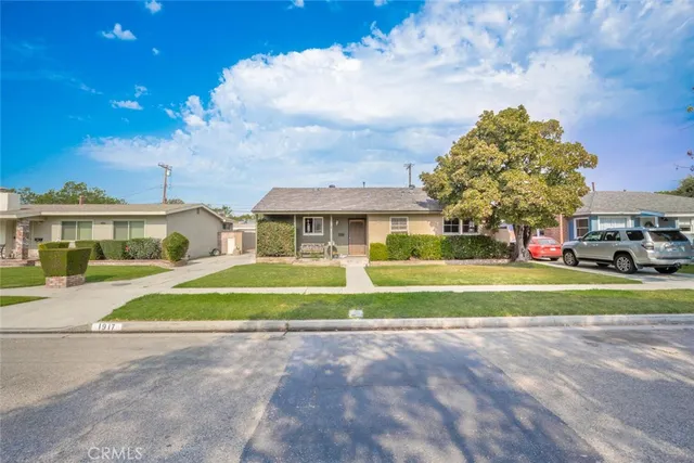 a view of an house with backyard space and balcony