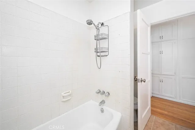 a view of a big room with wooden floor closet and windows