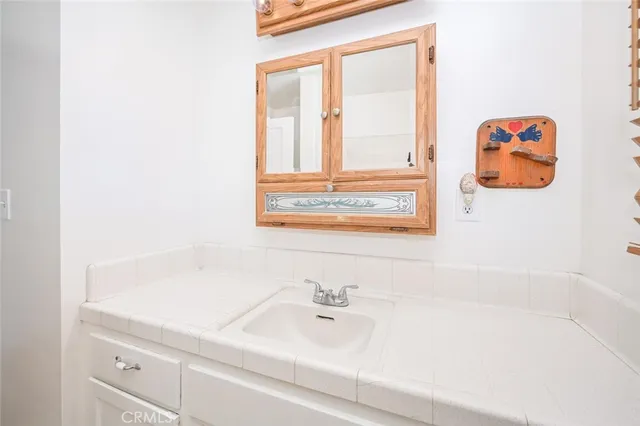 a view of a big room with wooden floor and windows