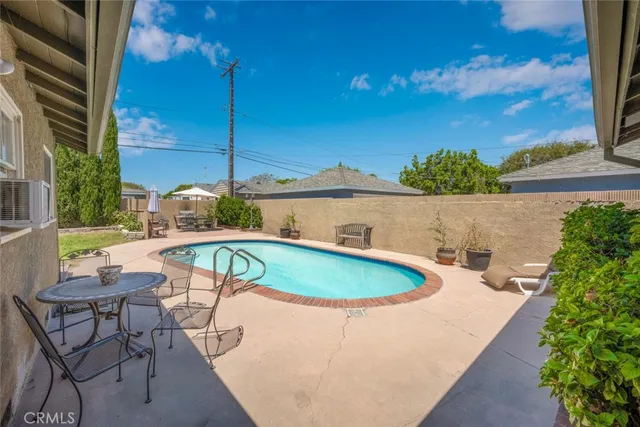 a view of backyard with outdoor seating and trees