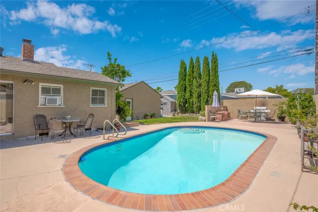 a view of an outdoor sitting area with furniture and umbrella