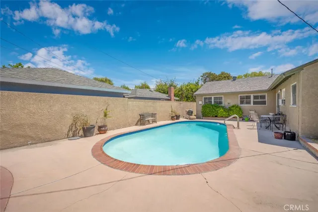 a view of a backyard with furniture and a garage