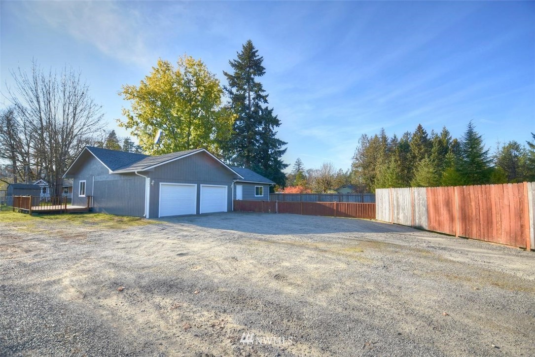 8231 James Road Southwest Rochester, WA 98579 - Photo 1 of 25 a yard with a large tree in front of it