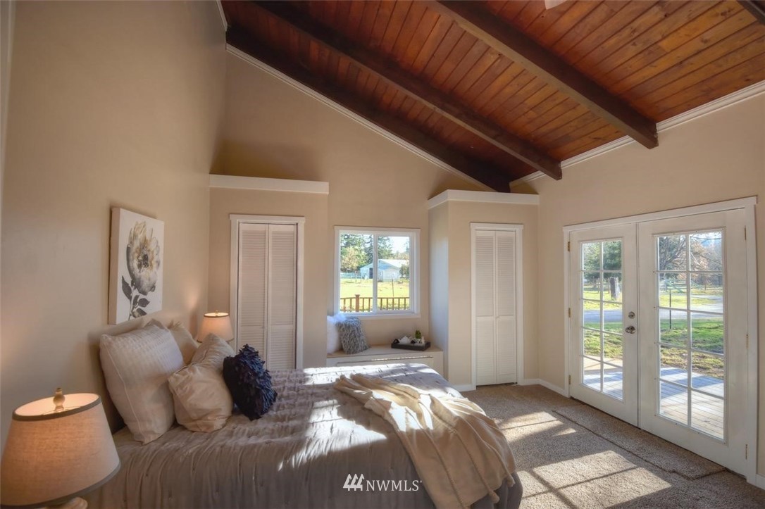 8231 James Road Southwest Rochester, WA 98579 - Photo 11 of 25 a bedroom with a bed and wooden floor