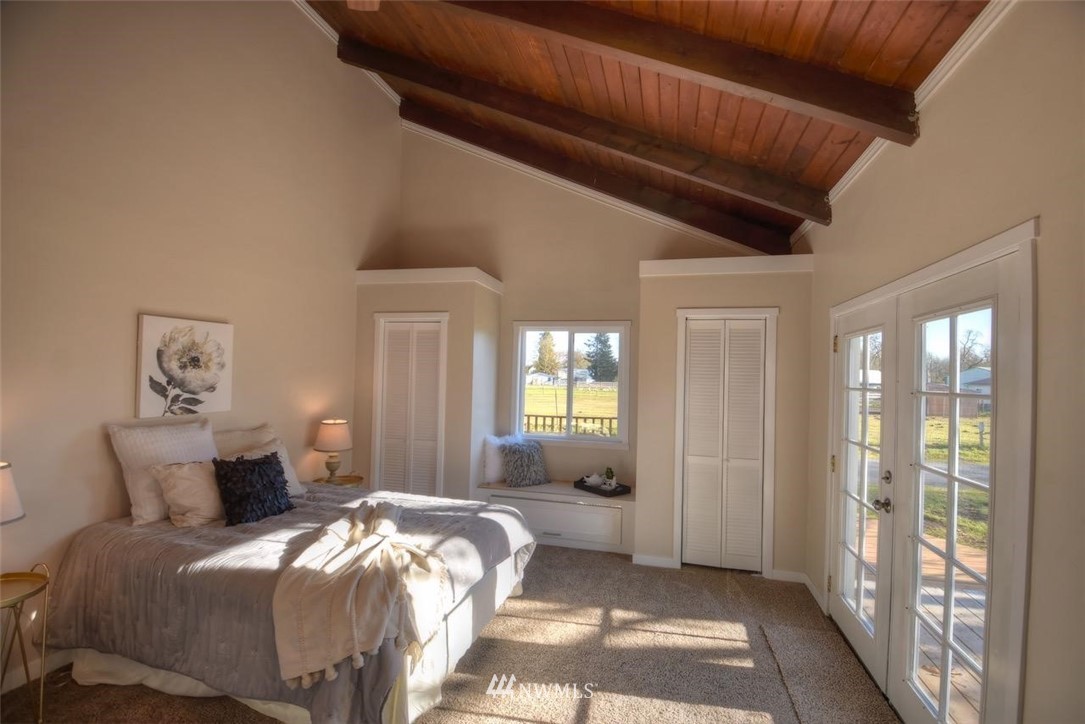 8231 James Road Southwest Rochester, WA 98579 - Photo 12 of 25 a spacious bedroom with a bed and a large window
