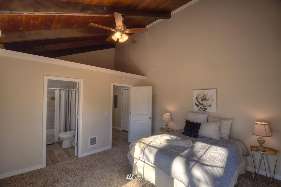 8231 James Road Southwest Rochester, WA 98579 - Photo 13 of 25 a bedroom with a bed and a lamp