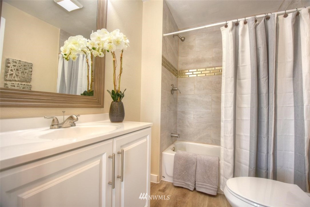 8231 James Road Southwest Rochester, WA 98579 - Photo 15 of 25 a bathroom with a granite countertop sink a toilet and a bathtub