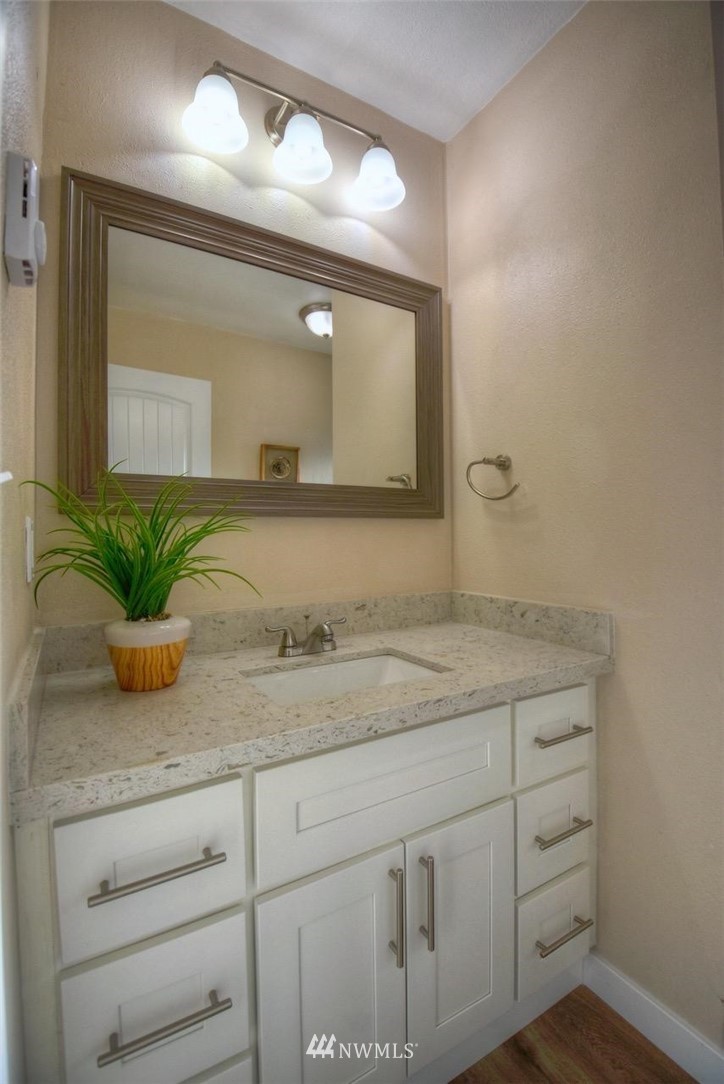 8231 James Road Southwest Rochester, WA 98579 - Photo 19 of 25 a bathroom with a granite countertop sink and a mirror