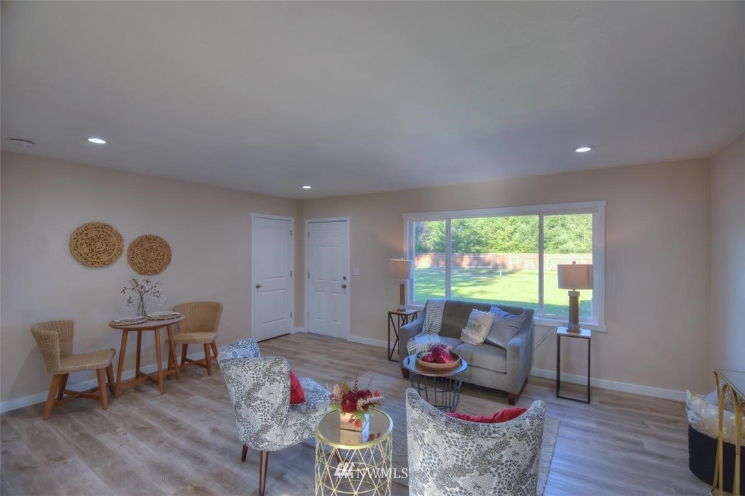 8231 James Road Southwest Rochester, WA 98579 - Photo 3 of 25 a living room with furniture and a floor to ceiling window