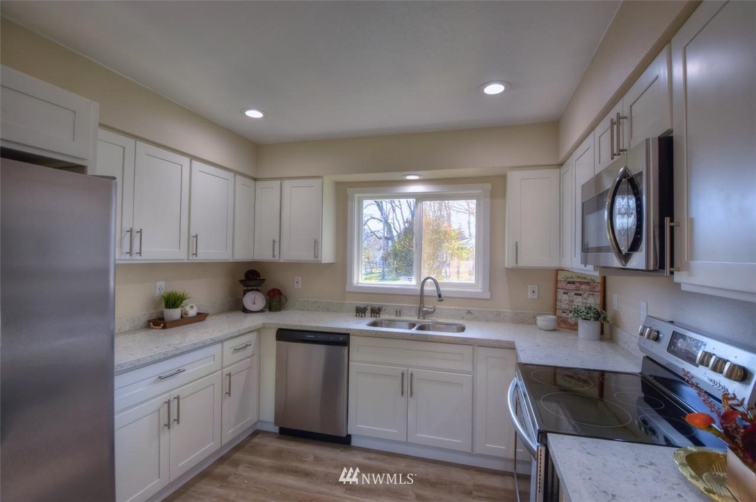 8231 James Road Southwest Rochester, WA 98579 - Photo 8 of 25 a kitchen with a sink stove and cabinets