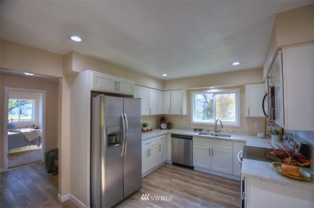 8231 James Road Southwest Rochester, WA 98579 - Photo 9 of 25 a kitchen with a sink stainless steel appliances and cabinets