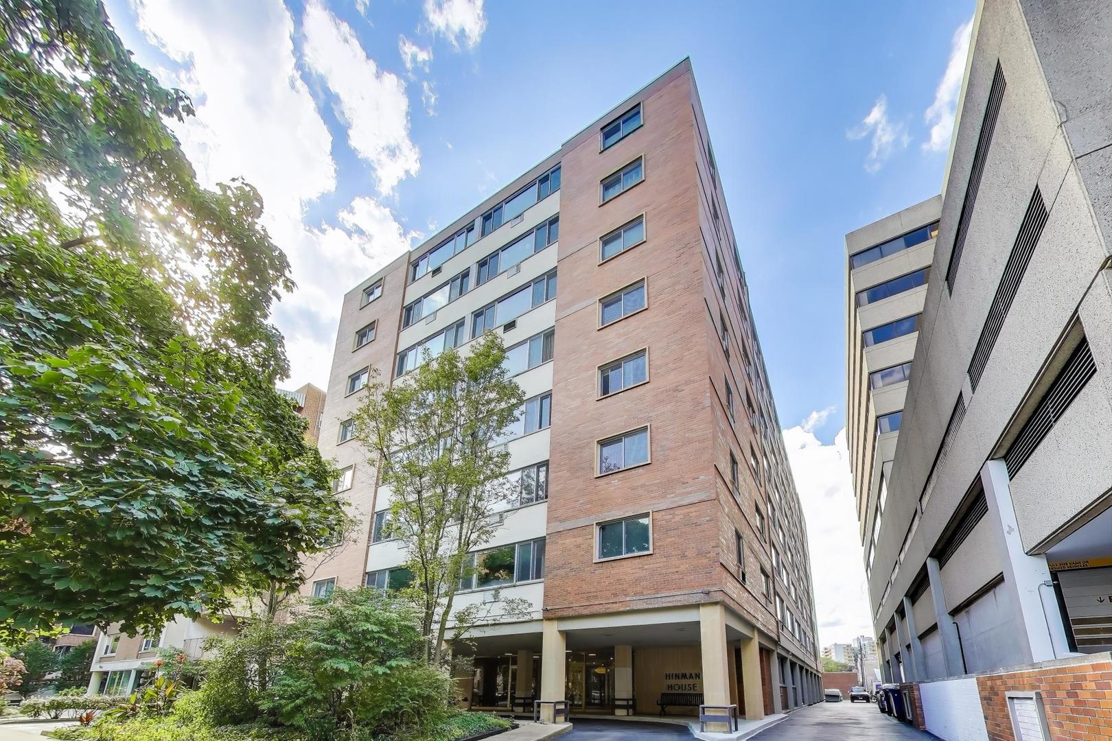 a front view of a multi story building with a yard