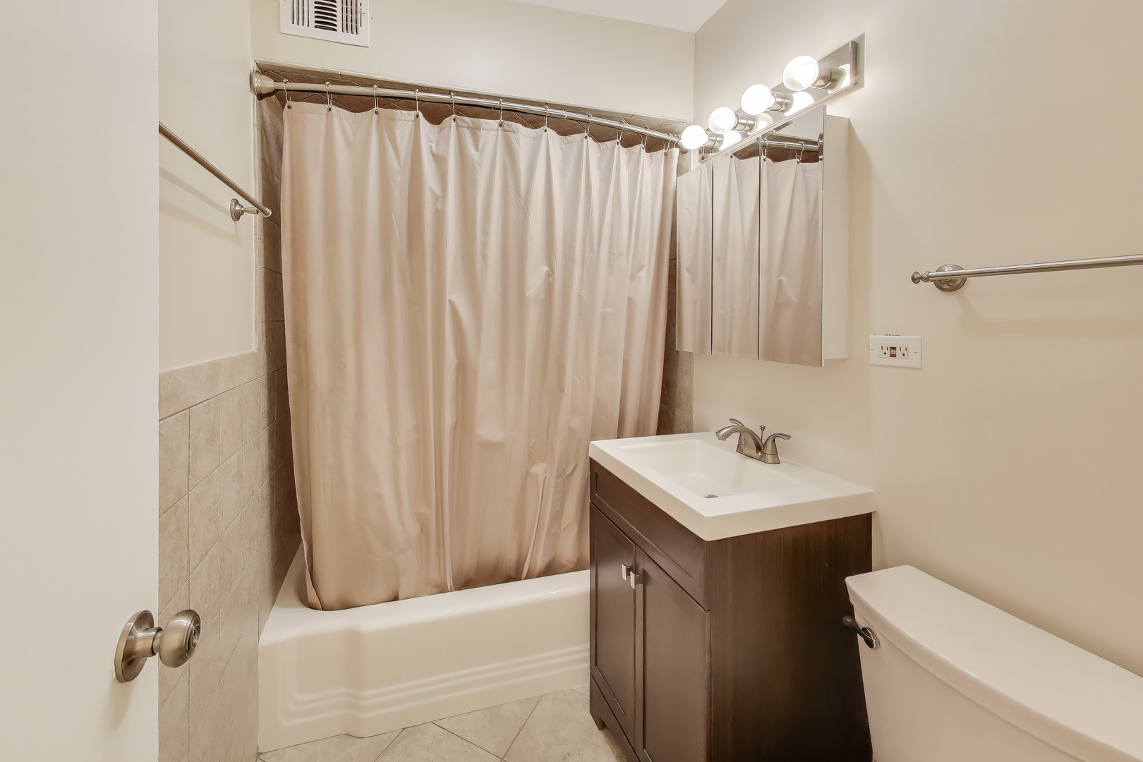 1516 Hinman Avenue, Unit 211 Evanston, IL 60201 - Photo 11 of 13 a bathroom with a sink a toilet and shower