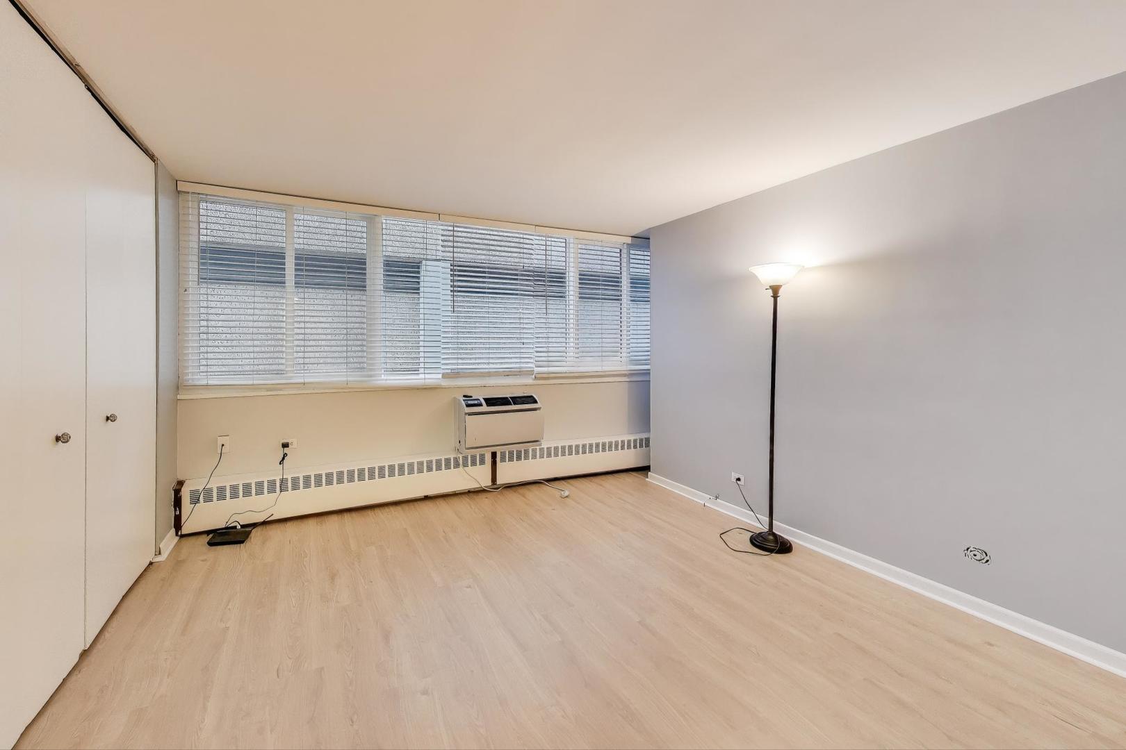 1516 Hinman Avenue, Unit 211 Evanston, IL 60201 - Photo 6 of 13 an empty room with wooden floor and windows