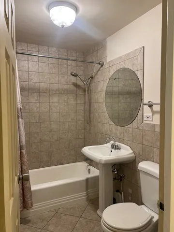 a bathroom with a sink toilet and a mirror