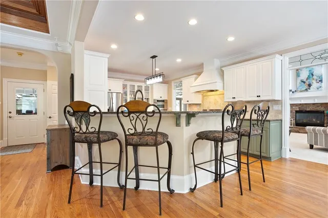a kitchen with granite countertop a sink stove and cabinets