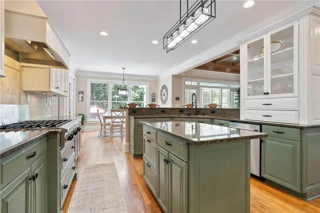 a kitchen with stainless steel appliances granite countertop a stove and a sink