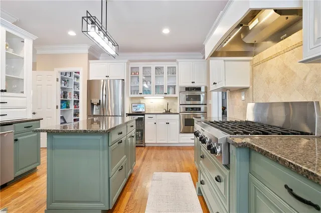 a kitchen with a sink cabinets and window