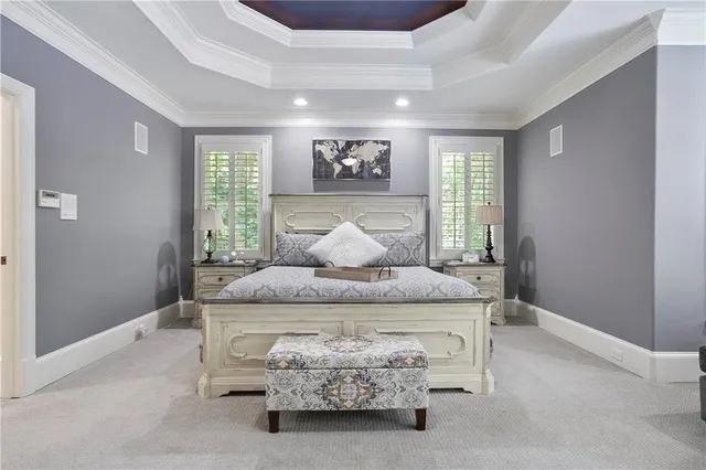 a spacious bedroom with a bed and a dresser