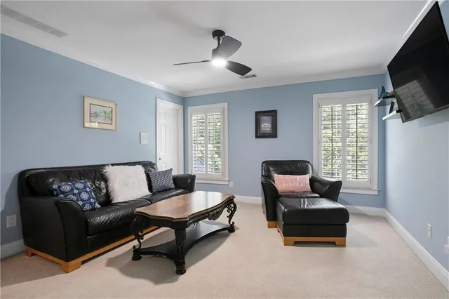 a bedroom with a bed and a flat tv screen on the dresser