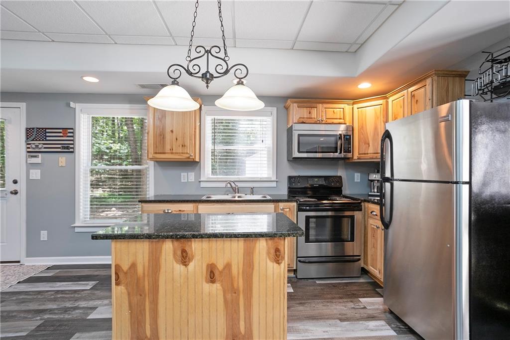 4185 Pool Road Winston, GA 30187 - Photo 46 of 57 a kitchen with granite countertop stainless steel appliances a counter space cabinets and a window