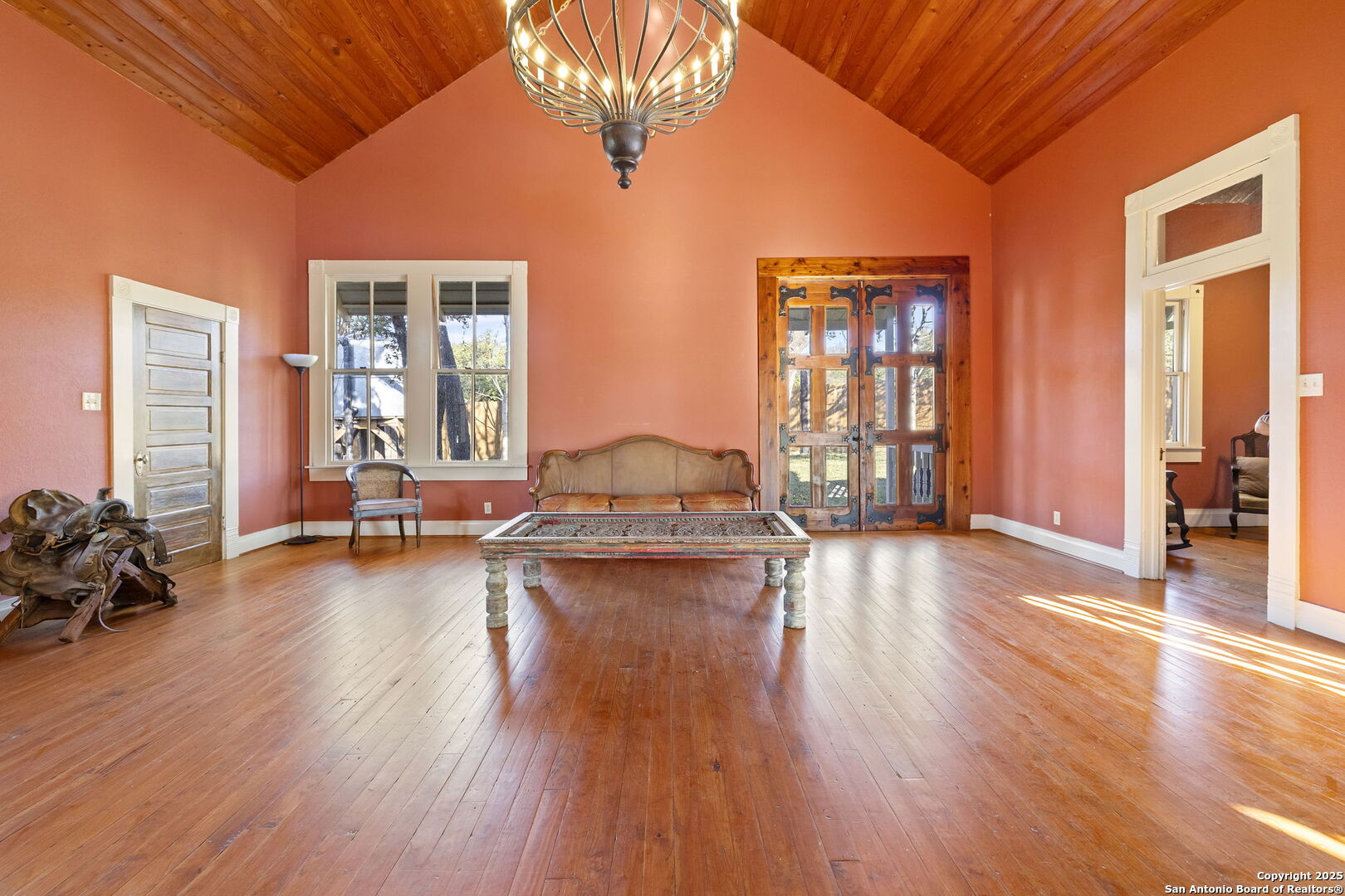 a living room with furniture and wooden floors