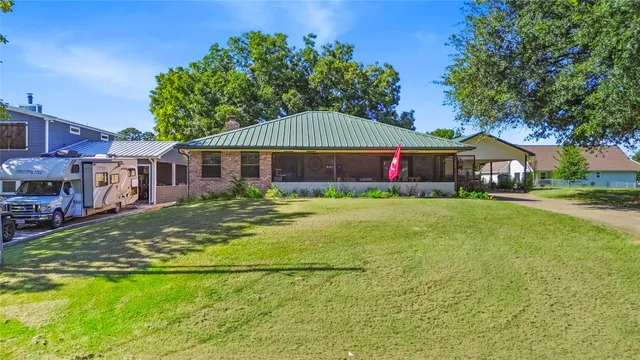 a house view with swimming pool and garden space