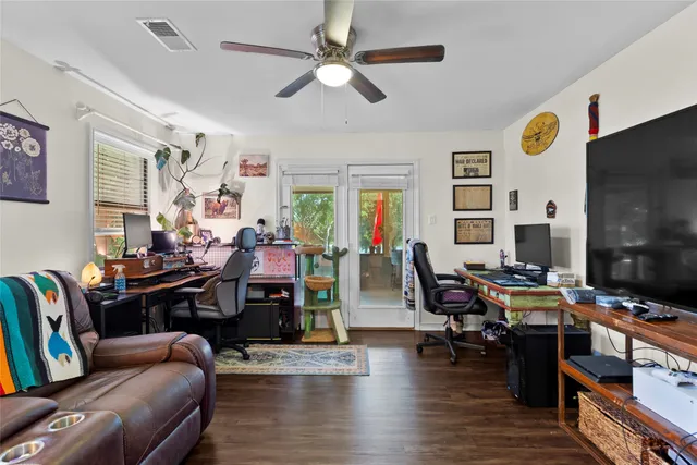 a living room with furniture kitchen view and a window