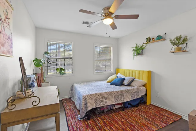 a bedroom with a bed a window and couch