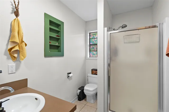 a bathroom with a toilet sink and shower
