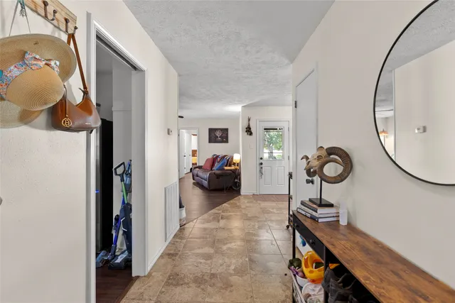 a view of a room that has a bed and a chandelier
