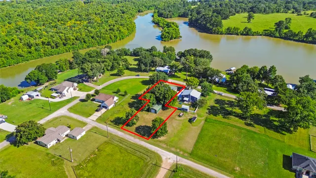 an aerial view of a pool yard patio and lake view