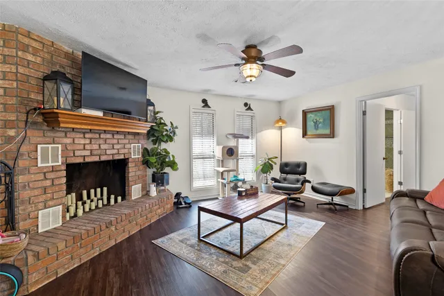 a living room with furniture a fireplace and a table