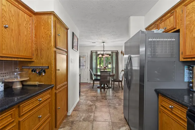 a kitchen with stainless steel appliances granite countertop a refrigerator and a sink