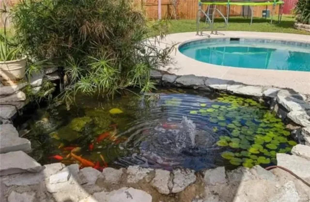 a view of a house with swimming pool and sitting area