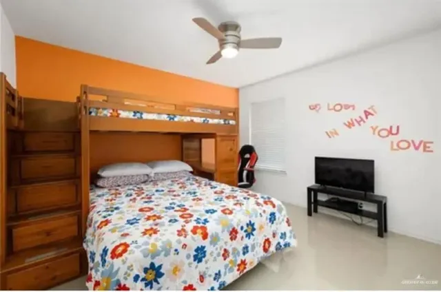 a bedroom with a bed and a flat screen tv