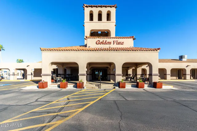 a view of a building with cars on the road