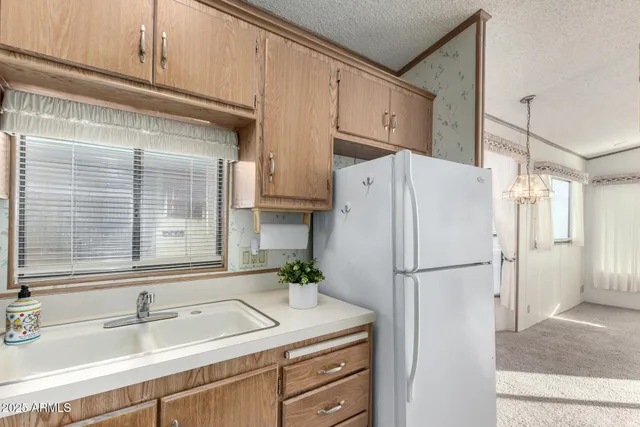 a kitchen with refrigerator cabinets and a sink