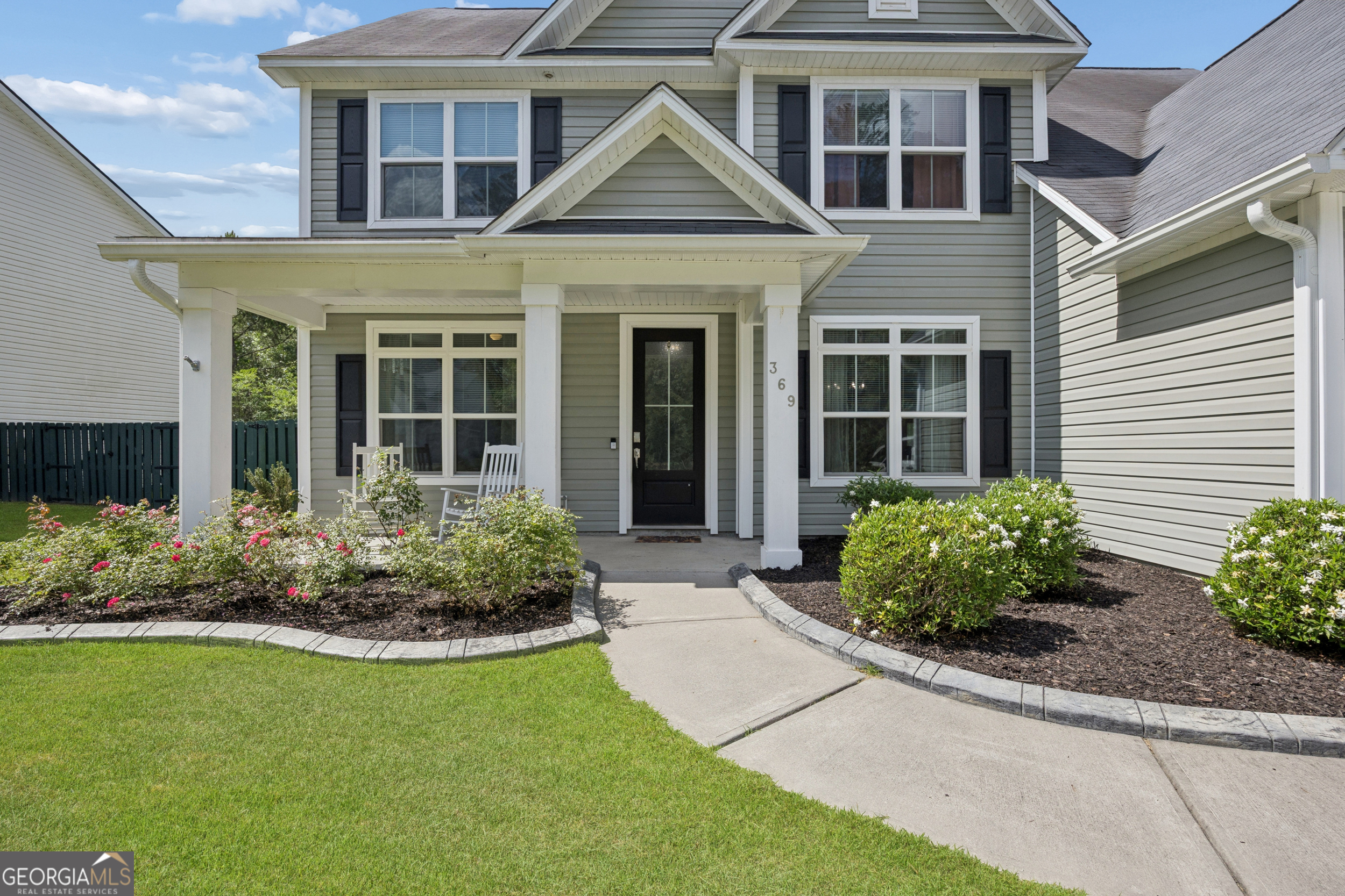 369 Waybridge Way Richmond Hill, GA 31324 - Photo 4 of 40 a front view of a house with a yard and outdoor seating