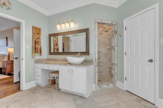 a spacious bathroom with a sink a mirror and a shower
