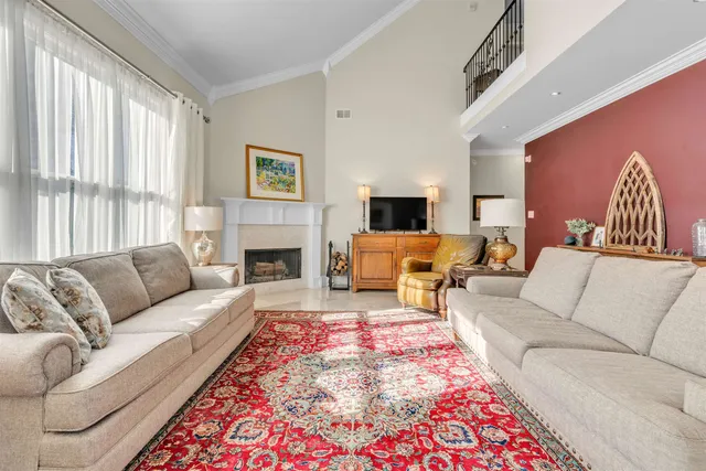 a living room with furniture fireplace and window