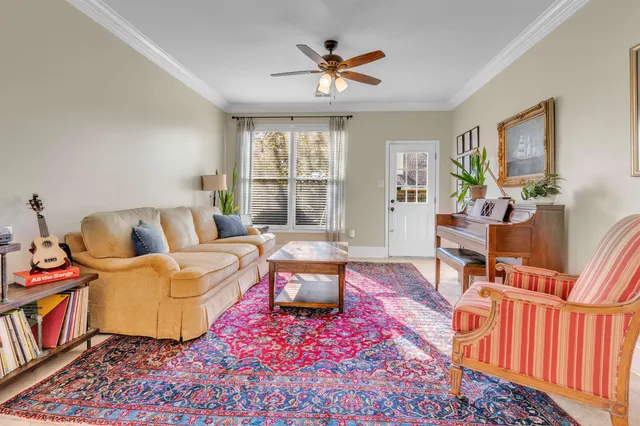 a living room with furniture and a chandelier