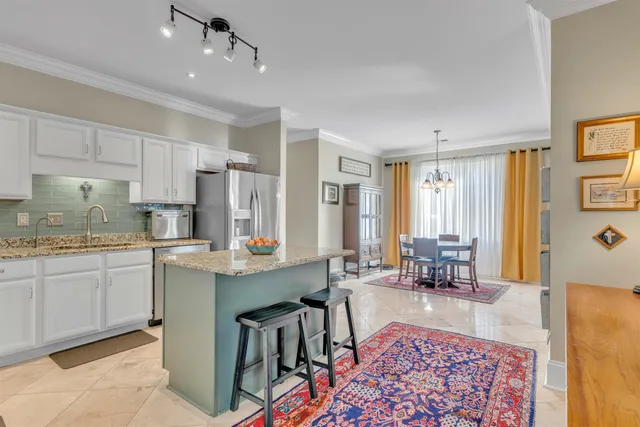 a living room with granite countertop furniture and a dining table