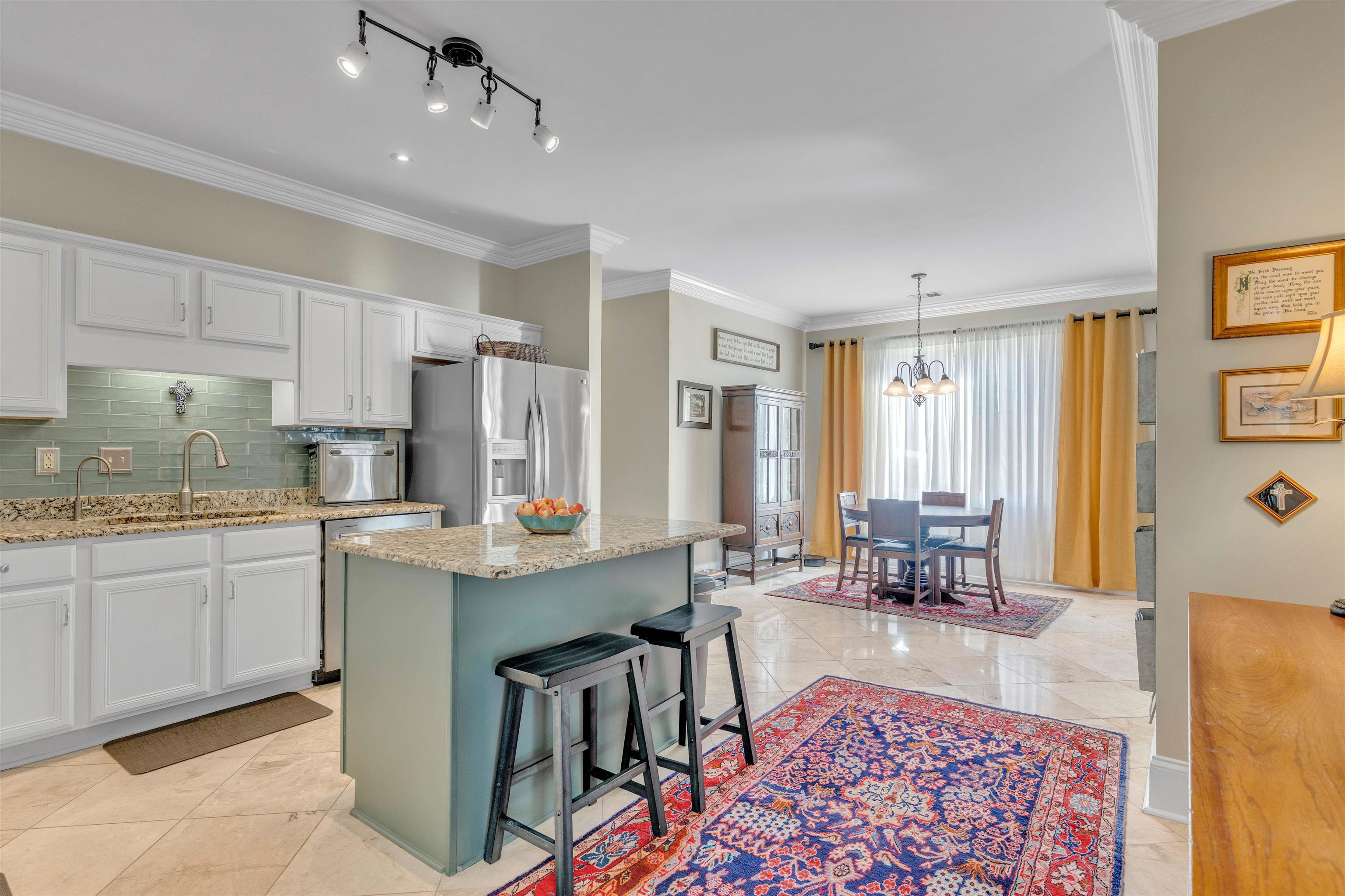 10489 Fireweek Lane Collierville, TN 38017 - Photo 6 of 39 a living room with granite countertop furniture and a dining table