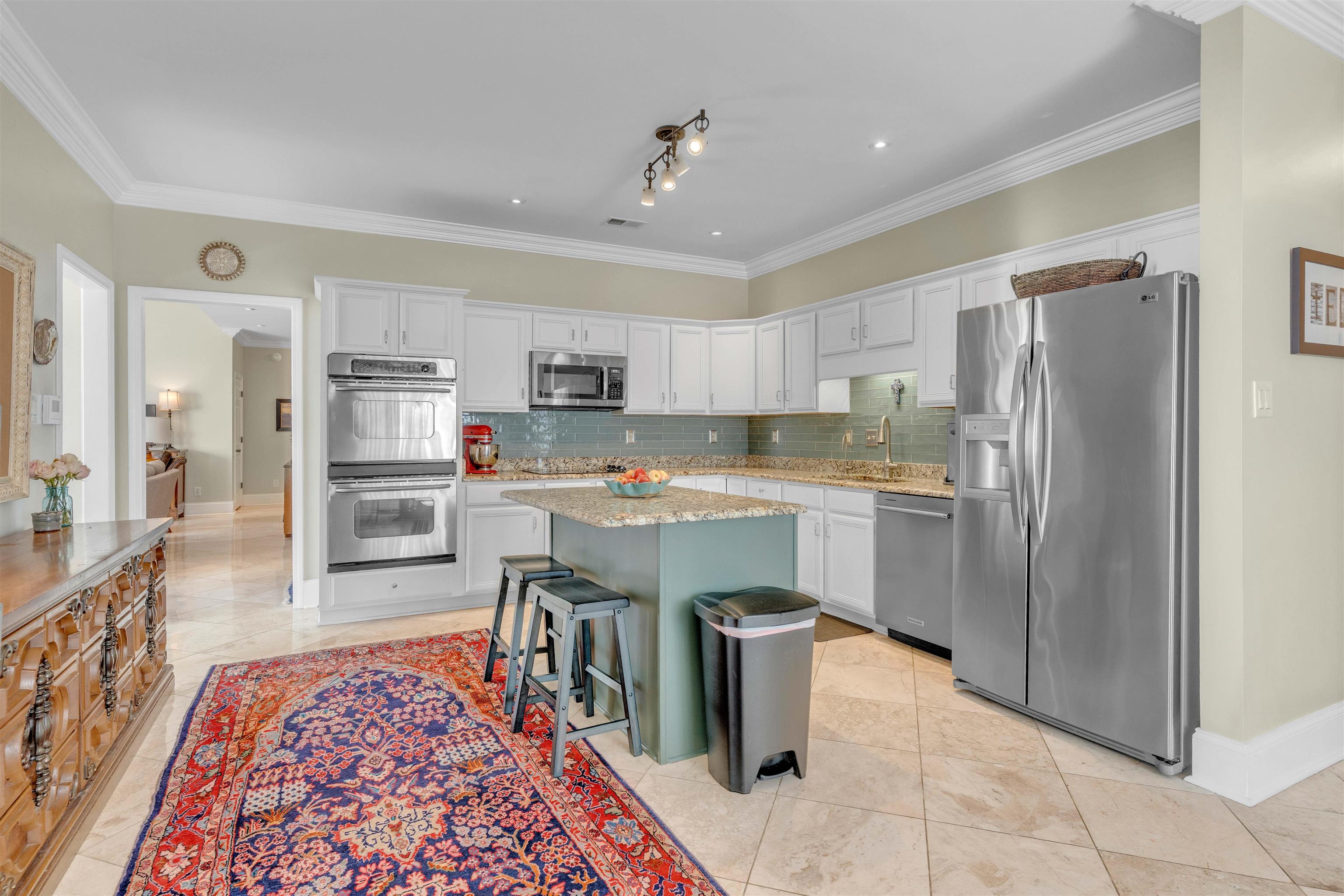 10489 Fireweek Lane Collierville, TN 38017 - Photo 8 of 39 a kitchen with stainless steel appliances granite countertop a refrigerator a stove top oven and sink with wooden floor
